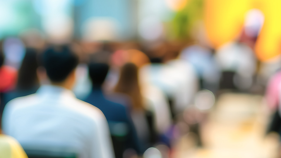 Blurred photo of a public meeting